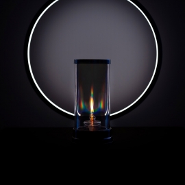 Prismatic oil lamp in front of a modern circular lamp.