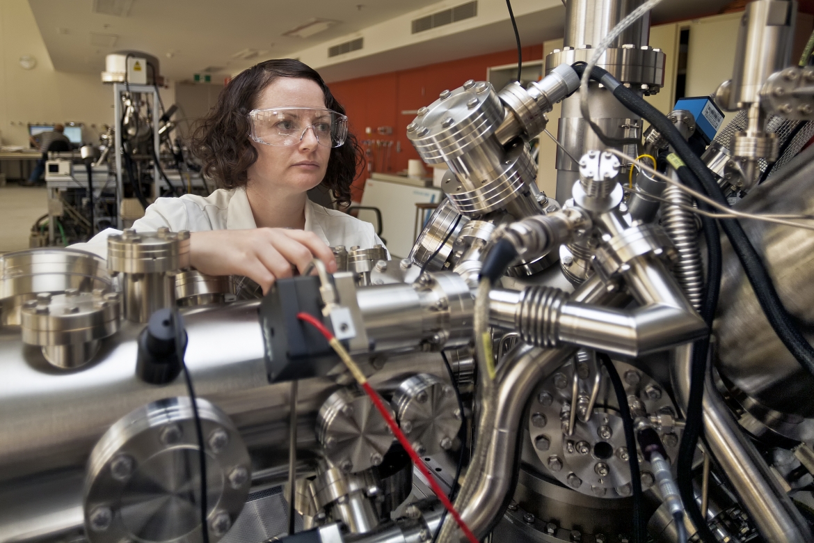 Female scientist in front of machine